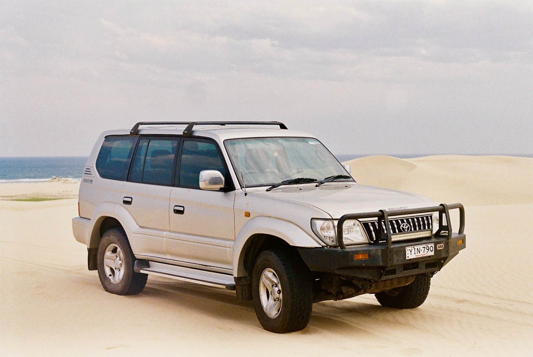 Toyota Prado on the sand dunes by the sea